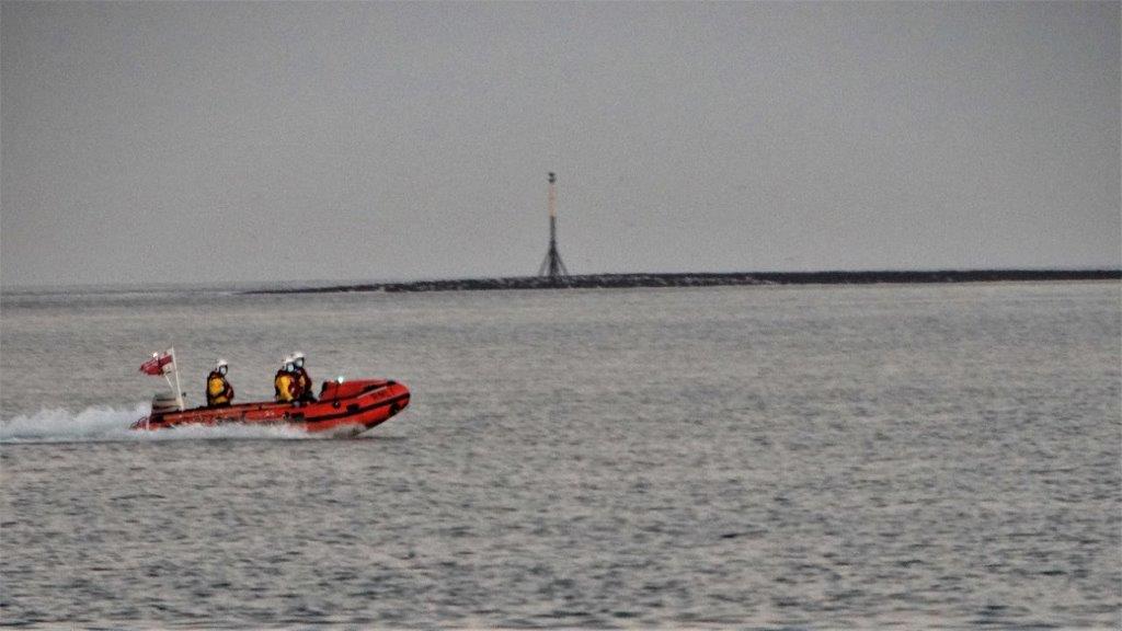 Persons cut off by tide